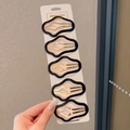 Five-piece set of star-shaped hair clips in black and gold on a display card - Black Set - 5 Pcs