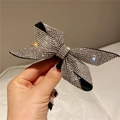 Elegant bow hair clip with sparkling silver rhinestones on a black base held in hand - Style C Hair Clip / White
