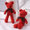 Cute red knitted teddy bear plush keychain with a dark brown ribbon bow detail - Red