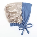 Detail of satin hair bonnet with champagne gold silk texture and blue adjustable ties - Denim Blue