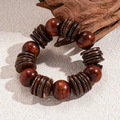 Macro shot of vintage wooden beaded bracelet with coconut shell discs on stone surface - Dark Coffee Round Style (Coffee Round Bracelet)