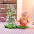 Cartoon monk figurine with gold ingot and glass vase on a green lotus leaf base - Holding Ingot in Hydroponic Vase
