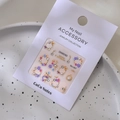 Floral 3D nail charms set with purple pink flowers and pearls on white retail display card - Model MJ-067 Gold Foil