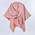 Detail of pink knitted poncho featuring fringe edges and front tie design for women - Solid Color Tassel Tie / Pink