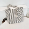 Detail of the high-quality striped canvas fabric and woven label on a casual tote bag - Navy Blue Stripes