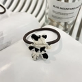Elastic hair tie with cute cow-print bear pendant and gold lettering on white book - Bear Cookie Hair Tie / Oreo (Cow Print)