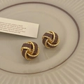 Macro detail of vintage gold twist earrings with brown enamel on a ceramic plate - Coffee Twist Stud Earrings