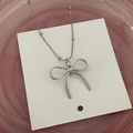 Silver bow pendant necklace with beaded chain on minimalist jewelry display card - Bead Chain Bow Style