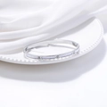 Elegant silver stainless steel bangle with shell inlay and cubic zirconia on porcelain - Silver