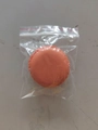Mini macaron style jewelry storage box in orange color within a clear plastic bag - Orange