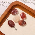 Macro detail of five oval natural strawberry quartz beads with reddish-brown polished textures - Reddish Brown Natural Texture Oval Style (0029号)