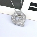 Close-up of silver-tone letter Q pendant necklace with white zircon pavé setting - Letter Q