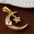 Macro shot of 24K gold-plated moon and star pendant with sparkling crystal inlay - Zirconia Star Moon - Gold