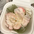 Macro shot of a floral hair clip with pink silk petals, white fabric flowers and pearls - Peony Pearl Hair Tie