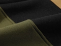 Close-up of olive green and black hoodie fabric with durable stitching details - Olive Green + Black