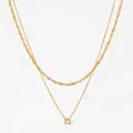 Double layered gold necklace featuring rope chain and zircon pendant on white background - Gold