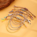 Close-up of colorful Bohemian woven friendship bracelets with tassels and beads - Light Beige Set