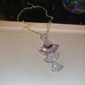Detail of fan-shaped golden necklace with purple gems and tassel pendant design - Necklace-Purple