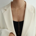 Minimalist Y-shaped long tassel necklace in 18k gold plated stainless steel on a model - Long / Gold