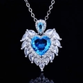 Macro shot of silver angel wing necklace featuring a heart-shaped blue gemstone - Aquamarine Diamond Pendant [No Chain]