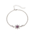 Detailed macro view of silver starburst bracelet featuring a purple center stone and crystals - Bracelet - Silver