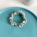 Sage green scrunchie with white floral daisy pattern on a ceramic display dish - 7# Green Floral