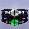 Luminous green dragon eye leather bracelet with multilayer braided bands on reflective surface - Yellow-Blue Textured Cat Eye Style