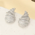 Macro shot of silver sea shell earrings with detailed textured folds on white stone - Silver Conch Style (N-204)