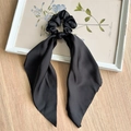 Detail of a black satin scrunchie with long ribbons on a vintage floral frame - Black