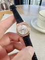 Close-up of luxury women's watch with rose gold diamond octagonal bezel and black leather strap - Black