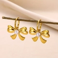 Elegant gold bow earrings with round white pearls hanging on a natural wooden branch - Bowknot Pearl Earring Set-E5072G