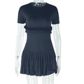 Detail of black mini dress featuring multi-layered pleated ruffles on the hem and sleeves - S / Black