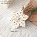 White snowflake ornament with gold glitter accents and hanging gold string - Snowflake: Style 6