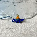 Macro shot of blue cartoon dinosaur enamel charm with gold loop for DIY jewelry - Blue Dinosaur 8-40