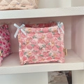 Close-up of pink floral quilted storage basket with blue ribbon bows and bunny print - Flower Yellow Rabbit