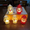 Luminous Christmas lanterns featuring Santa, snowman and tree patterns on a wooden table - Red Christmas Marquee Lamp