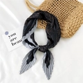 Pleated black silk scarf with retro polka dot pattern on elegant woven straw bag - Uniform Dotted Black
