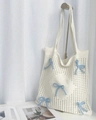 Detail of white hollow crochet tote bag featuring light blue ribbon bows and cotton texture - Apricot with Blue