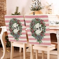 Close-up of pink Christmas chair covers featuring Joy wreaths and festive bows - Pink White Stripe JOY (YT02-22)