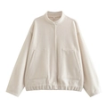 Close-up of cream fleece jacket featuring a high collar and soft sherpa texture - Off White