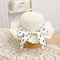 Close-up of beige woven straw hat with lace edges and a polka dot ribbon bow - 52cm (2-5 Years) / Milk White Straw Hat