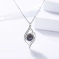 Detailed view of teardrop necklace with zircon paving and black projection stone - Irregular Shape White Gold Color