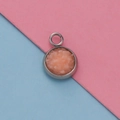 Detailed view of a silver 12mm round pendant tray with a pink stone inlay for DIY jewelry - Pink Spar Style (14)