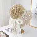 Light khaki crochet straw sun hat with floral lace, pearls, and a large mesh bow tie - Beige
