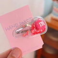 Pink heart-shaped glitter hair clip with m-letter detail on a pink display card - M Bean