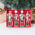 Close-up of four wooden 13cm Christmas Nutcracker soldier ornaments in a red gift box - Green (4PCS Set)