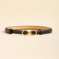 Close-up of slim black leather belt with a golden oval metal buckle on a beige backdrop - Black