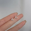 Detailed shot of small 925 silver cherry stud earrings held between fingers for size - Small Cherry / Silver