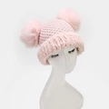 Close-up of pink winter knit hat featuring dual fox fur pom-poms and plush earflaps - Double Pom Poms / Pink