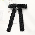 Detail of elegant black mesh bow hair clip with hand-stitched black beadwork and grid pattern - Black Rhombus Beaded Bow Clip